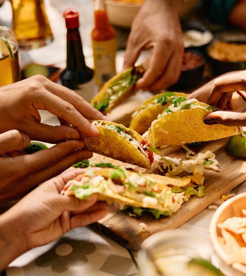 Close up of people eating Mexican food in a restaurant.